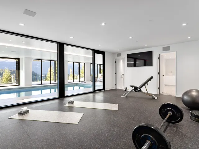 Workout area with rubber floors, recessed lighting, and floor to ceiling windows