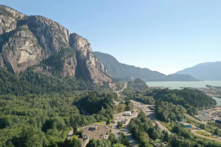 Property view of mountains with a forest view and a water view