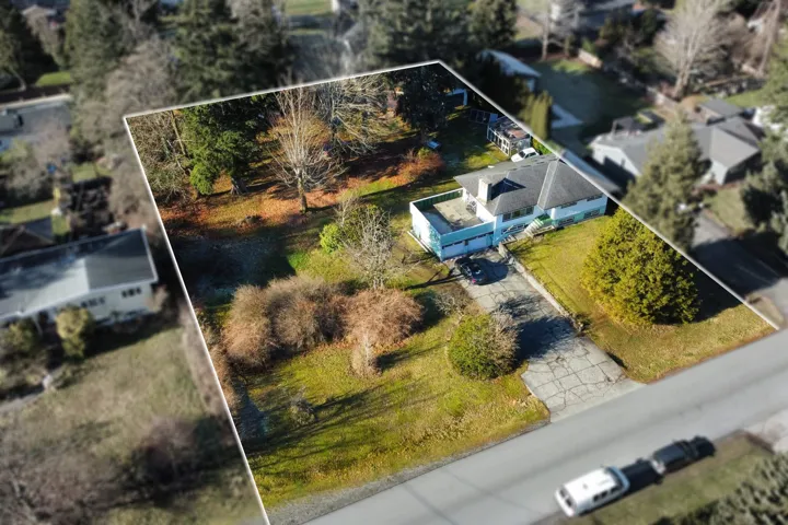 Aerial view of property and surrounding area featuring property parcel outlined
