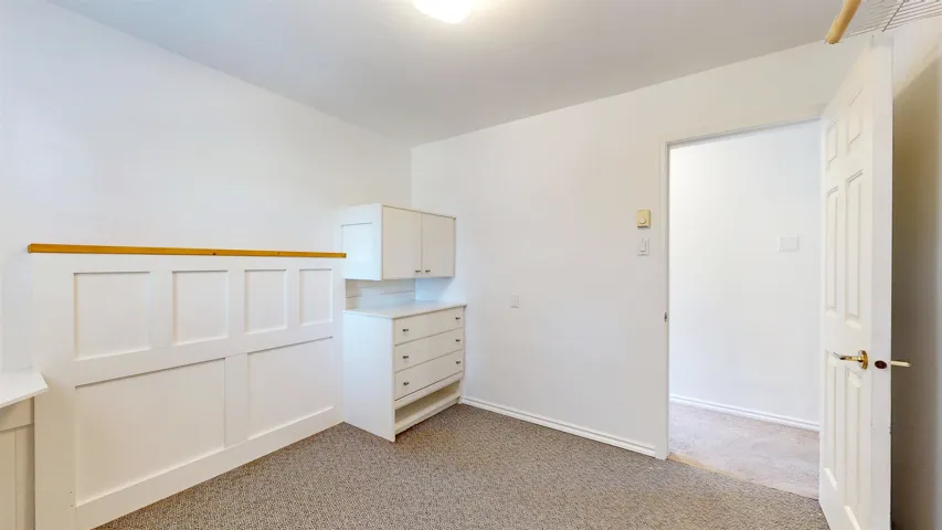 Unfurnished bedroom with light colored carpet