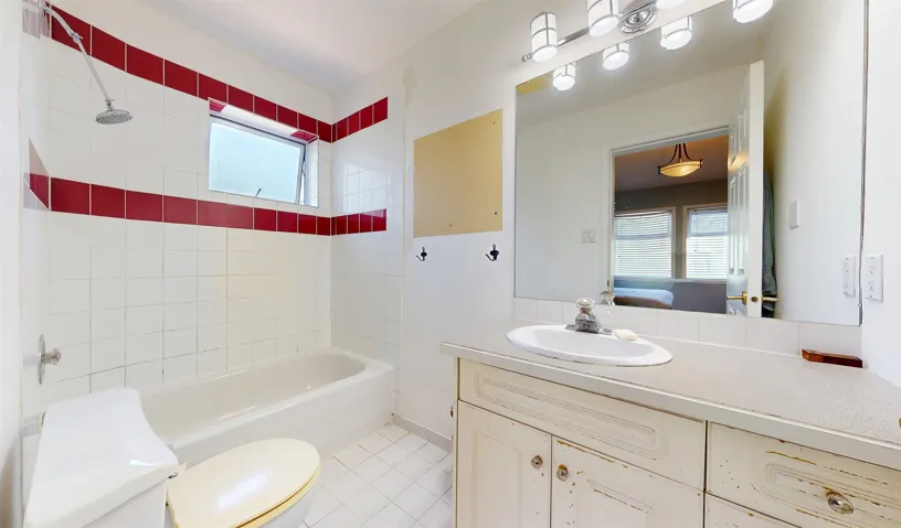 Full bathroom featuring vanity, plenty of natural light, tile patterned floors, and shower / tub combination