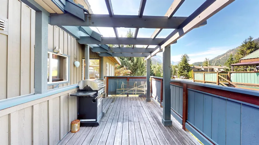 Wooden deck with a grill and a mountain view