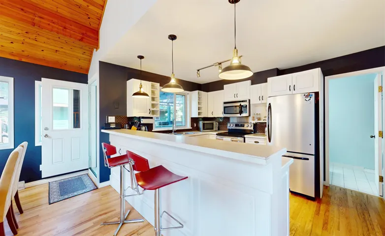 Kitchen featuring appliances with stainless steel finishes, open shelves, light wood-style flooring, light countertops, and wood ceiling