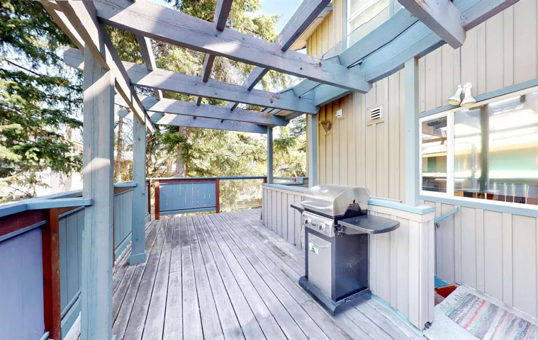 Wooden terrace featuring grilling area