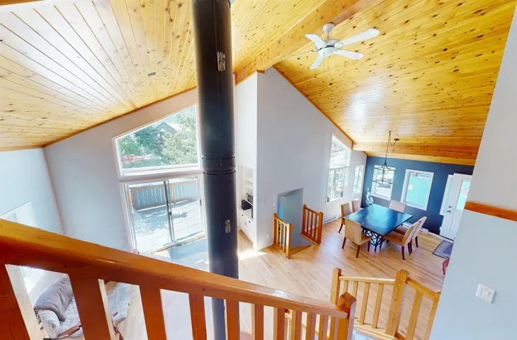 Interior space featuring wooden ceiling, wood finished floors, vaulted ceiling, and a chandelier