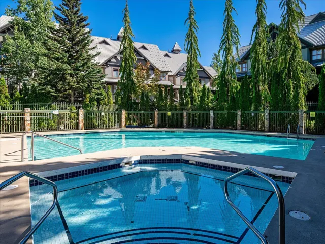 Pool with fence and a hot tub