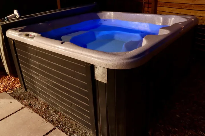 Exterior view of a hot tub and a cooling unit