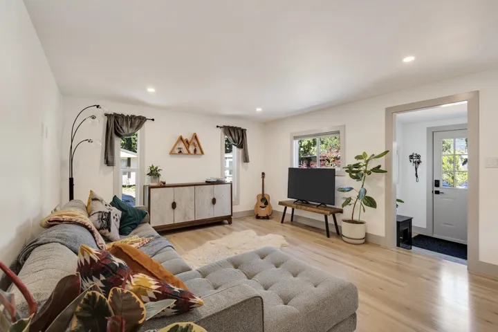 Living room with wood finished floors and recessed lighting