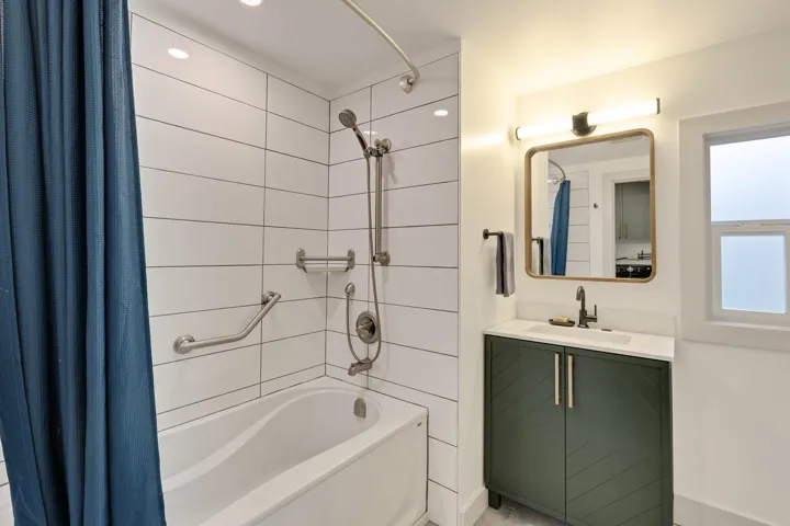 Bathroom featuring shower / tub combo and vanity