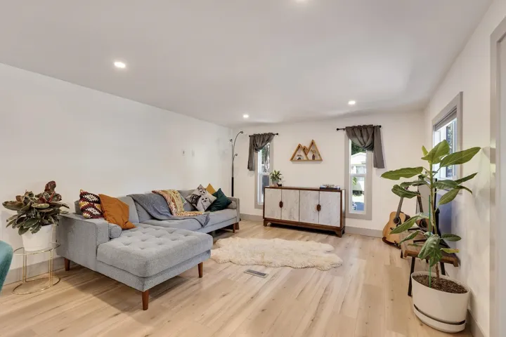 Living room featuring wood finished floors and recessed lighting