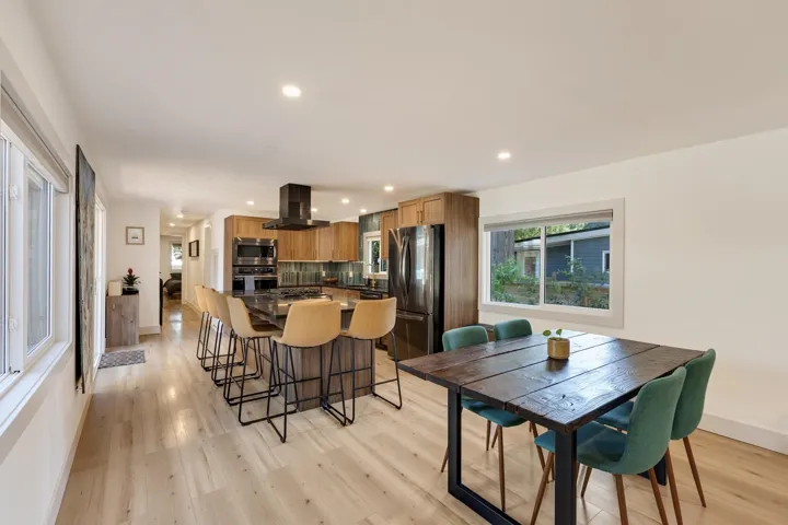 Dining area with light wood-style floors and recessed lighting