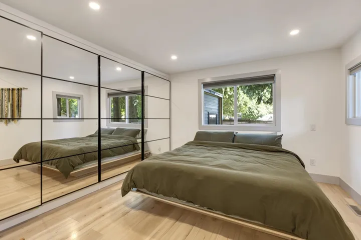 Bedroom featuring multiple windows, wood finished floors, and recessed lighting