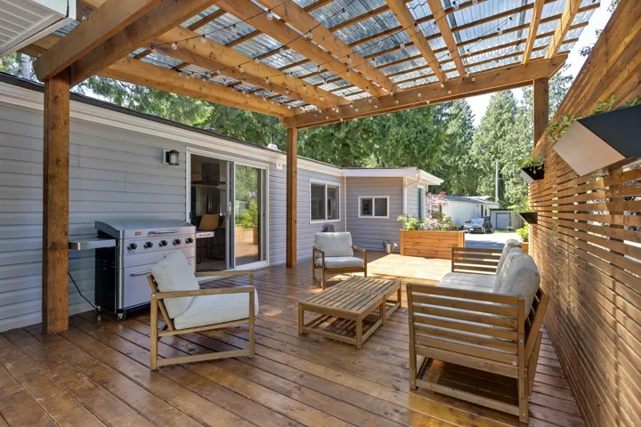 Wooden terrace with a pergola, an outdoor living space, and grilling area
