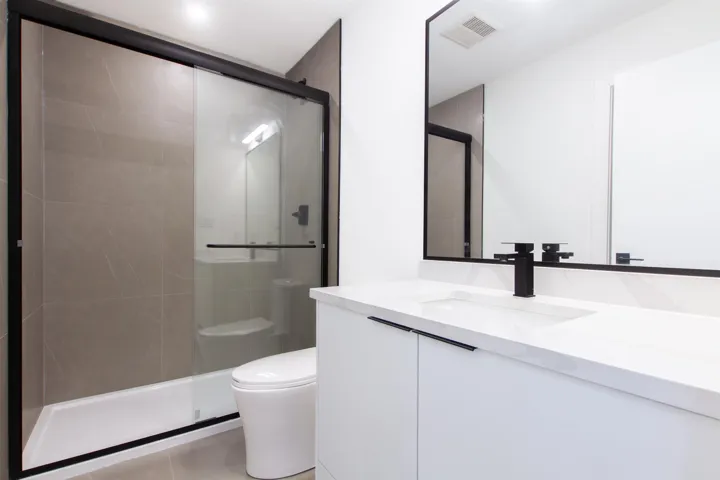Bathroom with a shower stall, toilet, and vanity