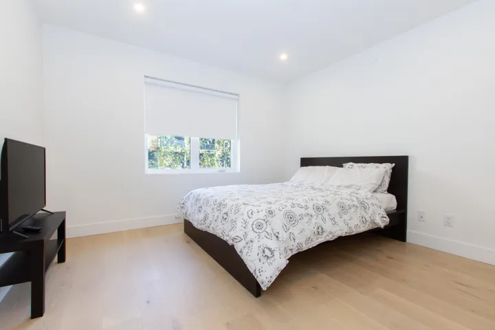 Bedroom featuring baseboards, light wood-type flooring, and recessed lighting