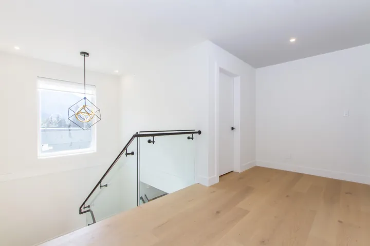 Stairs with wood finished floors, recessed lighting, baseboards, and a chandelier