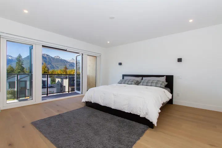 Bedroom featuring multiple windows, light wood-type flooring, baseboards, and recessed lighting