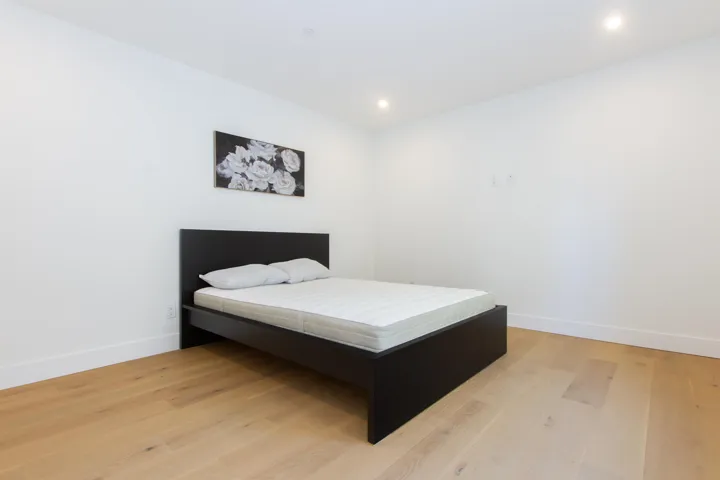 Bedroom featuring light wood-style flooring, baseboards, and recessed lighting