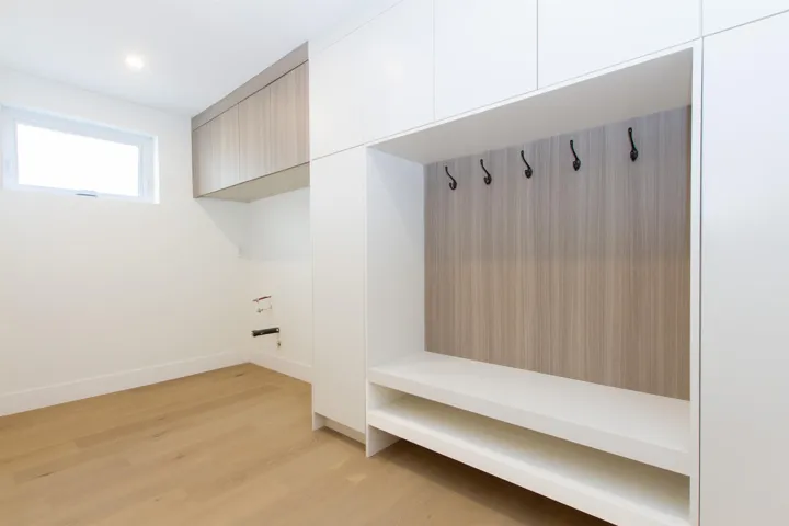 Mudroom with light wood-style floors and baseboards