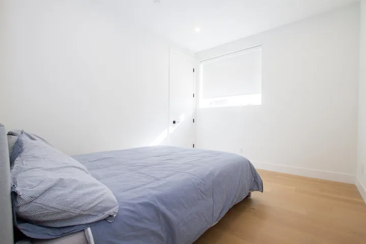 Bedroom featuring light wood finished floors and baseboards