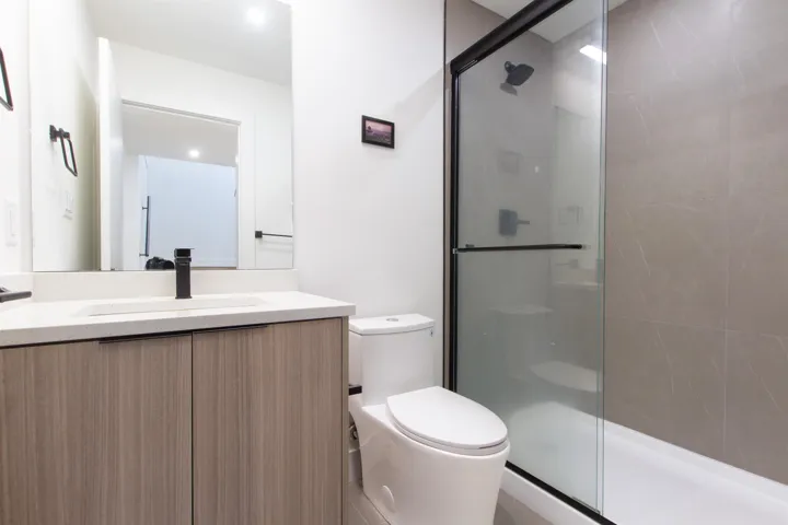 Full bath with a stall shower, toilet, and vanity