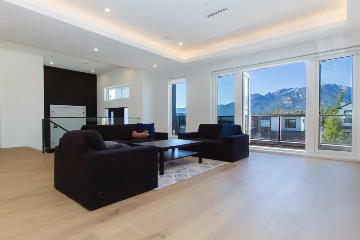 Living room featuring recessed lighting, a raised ceiling, a mountain view, and light wood-style floors