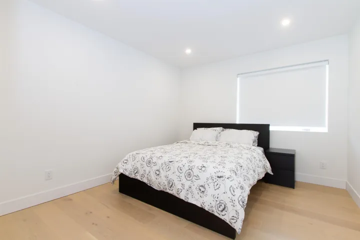 Bedroom featuring light wood-style floors, baseboards, and recessed lighting