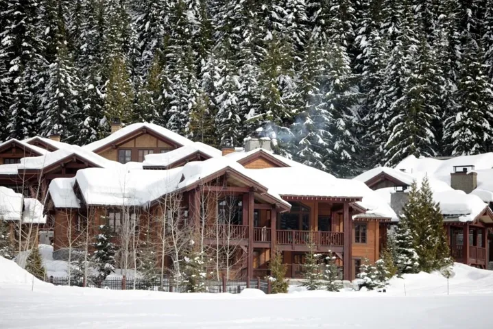 Snow covered house with a chimney and a balcony