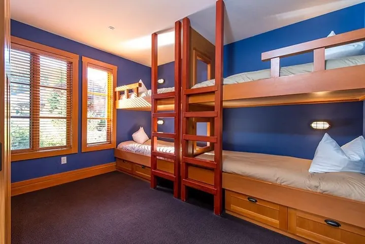 Bedroom featuring dark colored carpet and baseboards
