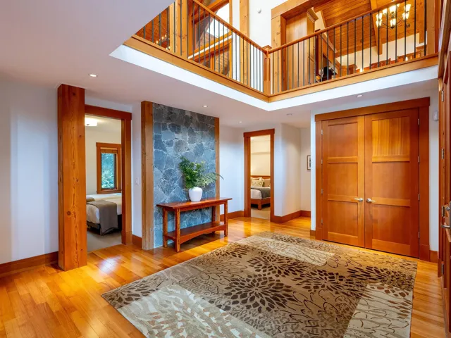 Entrance foyer featuring a high ceiling, light wood-style floors, and recessed lighting
