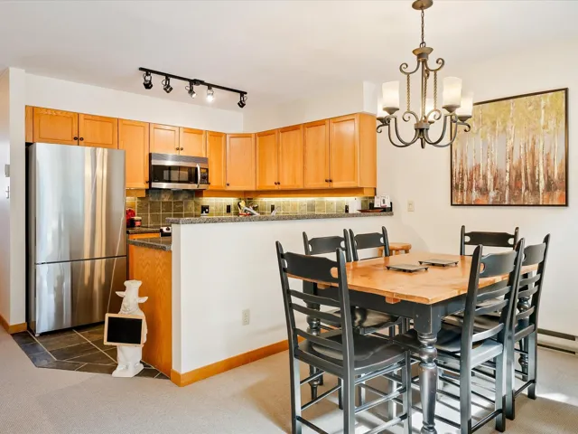 Dining area featuring an inviting chandelier and baseboards