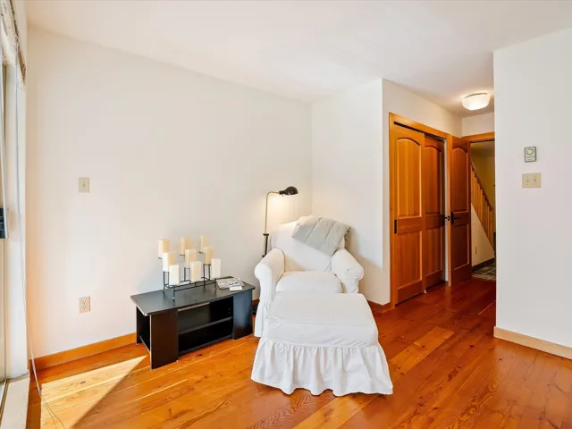 Living area with light wood-style flooring and baseboards