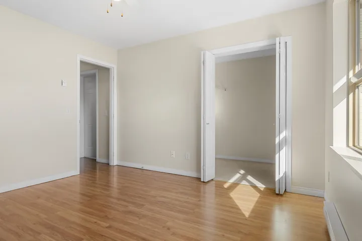 Unfurnished room featuring baseboards and light wood finished floors