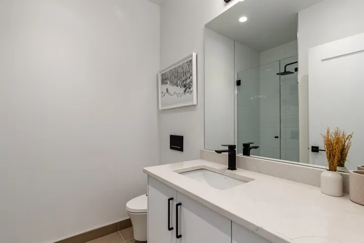 Bathroom featuring vanity, a stall shower, and light tile patterned floors