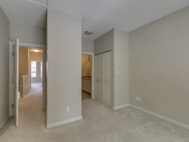 Unfurnished bedroom with light carpet and a closet