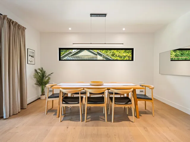 Dining area with light wood finished floors and recessed lighting