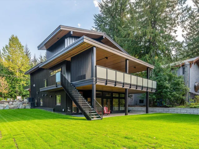 Back of house featuring a patio, a yard, stairway, and board and batten siding