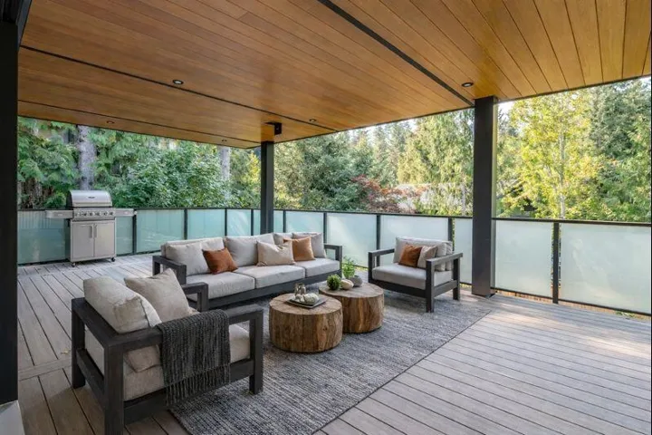 Wooden terrace featuring area for grilling and an outdoor hangout area