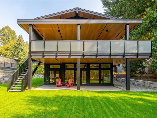 Rear view of property featuring a patio, a lawn, and stairway