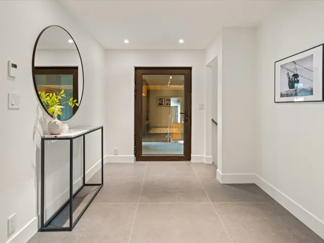 Hallway featuring recessed lighting and light tile patterned floors