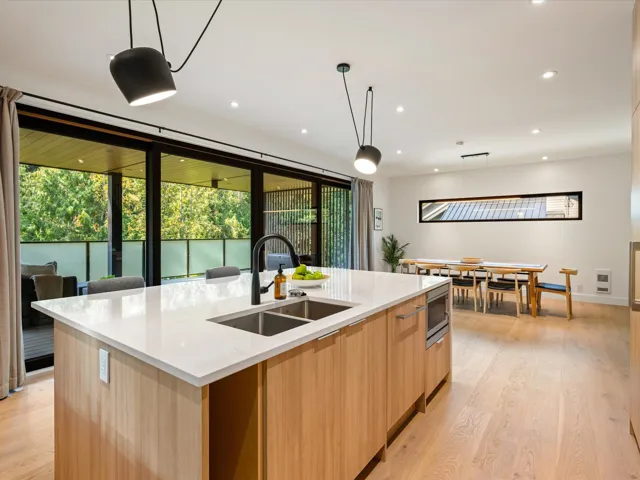 Kitchen featuring hanging light fixtures, light brown cabinets, modern cabinets, light wood-style flooring, and recessed lighting