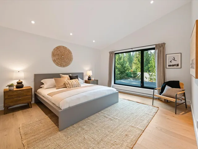 Bedroom with recessed lighting, light wood-style floors, a baseboard heating unit, and high vaulted ceiling