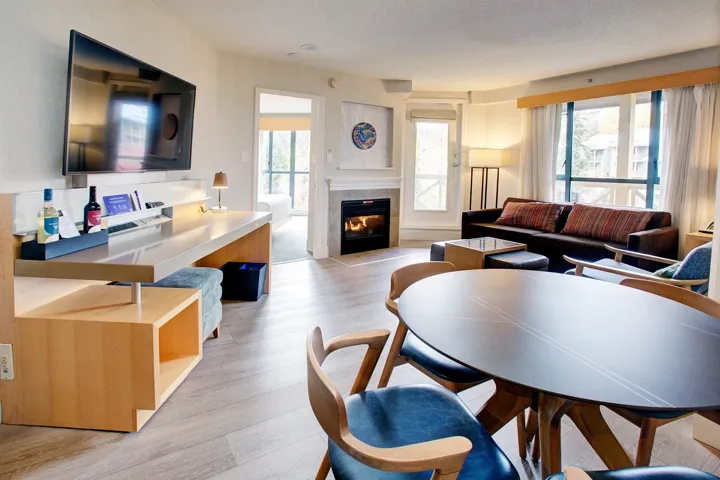 Living room featuring a tile fireplace and light wood-style floors