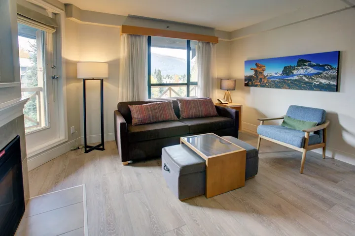 Living area featuring healthy amount of natural light, wood finished floors, and a fireplace