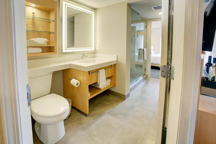 Bathroom with vanity, light tile patterned flooring, ensuite bath, and a stall shower