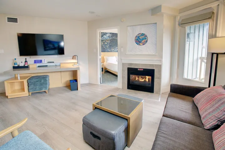 Living area with light wood finished floors and a tile fireplace