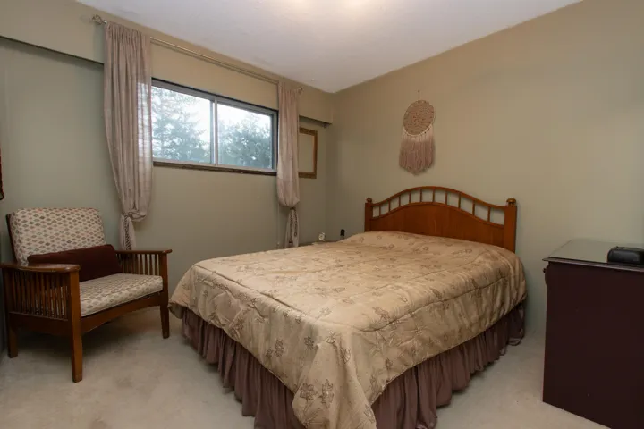 Bedroom with light colored carpet