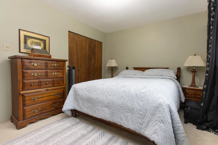 Bedroom featuring a closet and light colored carpet