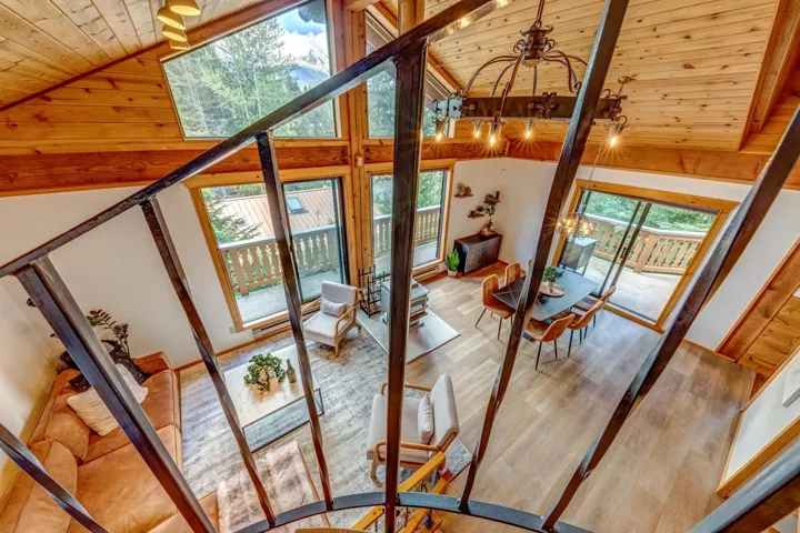 Doorway to outside with wooden ceiling, plenty of natural light, wood finished floors, and high vaulted ceiling