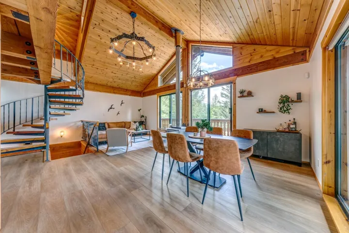 Dining space featuring a chandelier, stairs, wooden ceiling, wood finished floors, and high vaulted ceiling